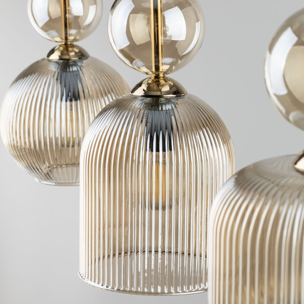 Detail of the slim canopy holding the three SOPHIA glass shades